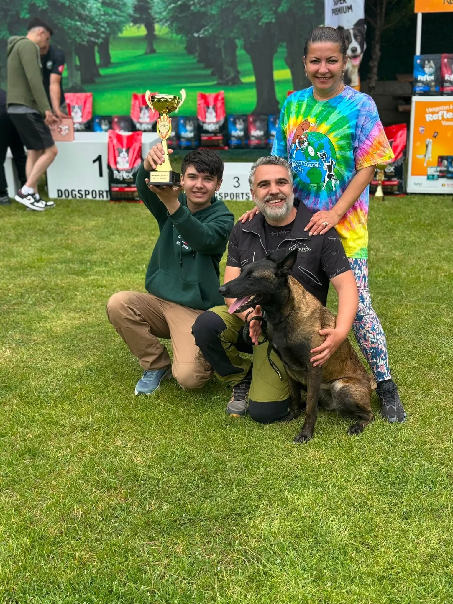 The PatiLee founding family with their dog and a first-place trophy